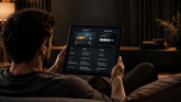 Man comparing Google TV and Android TV on a tablet.